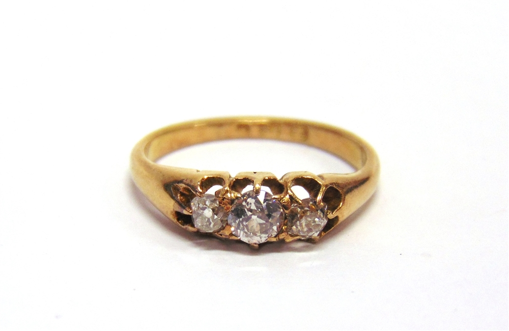 A LATE VICTORIAN THREE STONE DIAMOND 18 CARAT GOLD RING date letter erased, the graduated old