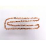 ROMA GALTON: A 9 CARAT ROSE GOLD CHAIN London 1982, of flat round links, 97cm long, 36g gross