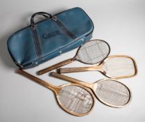 A group of four tennis racquets,