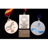 A group of four medals for aquatic sports,