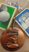 A miscellany of golf collectibles, including pin badges featuring Penfold and Dunlop men,