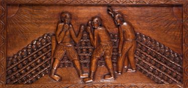 A 20th century African carved wooden panel of a boxing match, depicting two boxers,