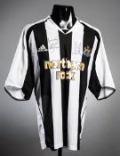 A Newcastle United replica home jersey double-signed by Alan Shearer and Sir Bobby Robson,
