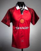A Manchester United replica home jersey signed by Eric Cantona,