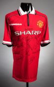 A Manchester United replica home jersey signed by the 1998-99 Treble winners,