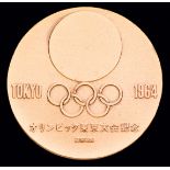 A gold medal commemorating the 1964 Tokyo Olympic Games, stamped .
