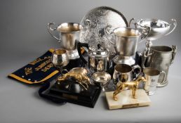 A group of greyhound racing trophies won by Dolores Rocket and her progeny, mostly silver plated,