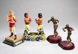 Four boxing figurines, two similar metalware figures of amateur boxers, one larger at 20cm., 8in.