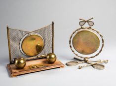 A tennis-themed dinner gong/desk stand, the gong suspended within a tennis net,