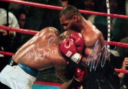 A double-signed colour photograph of the infamous ear biting incident during the Mike Tyson v