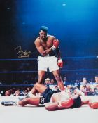 Muhammad Ali/Cassius Clay signed "phantom punch" colour photograph, a 20 by 16in.
