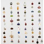 A collection of racing badges for British racecourses, mounted onto a painted hardwood panel,