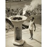 A period photograph of the athlete John Mark lighting the cauldron at the London 1948 Olympic Games,