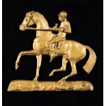 A Regency period gilded brass racehorse & jockey, mounted on velvet within a maple frame,