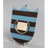 A racing plate worn by L'Escargot when winning the 1975 Grand National,