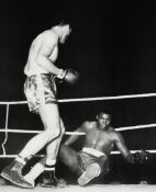 Henry Cooper signed photographic print, b&w showing his opponent Cassius Clay on the canvas,