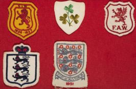 A collection of five international football shirt badges, comprising: a Scotland v Wales 1936-1937,