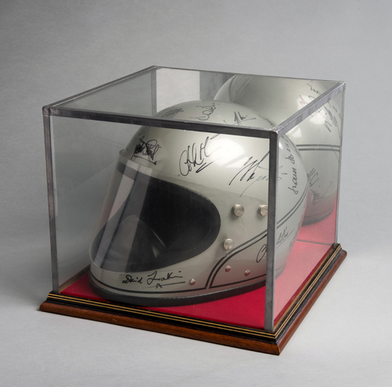 A vintage silver Stadium Achilles crash helmet signed by 20 personalities from motor sport,
