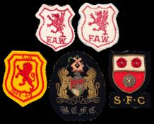 A group of five Ernie Jones football badges,