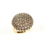 9 ct yellow gold diamond cluster ring. Set with round brilliant cut diamonds.