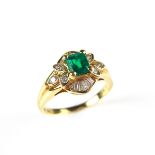 18 ct yellow gold emerald and diamond ring. The emerald cut emerald weighing approx. 0.