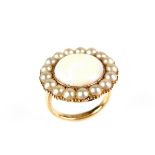9 ct yellow gold opal and pearl ring. The circular opal cabochon weighing approx. 4.