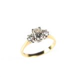 18 ct yellow gold diamond trilogy ring. Set with an emerald cut diamond weighing approx. 0.
