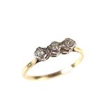 9 ct yellow gold three stone diamond ring. Set with three circular old cut diamonds.