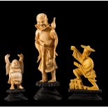 Three ivory sculpture on wooden bases, H cm 5.2/7/10.3