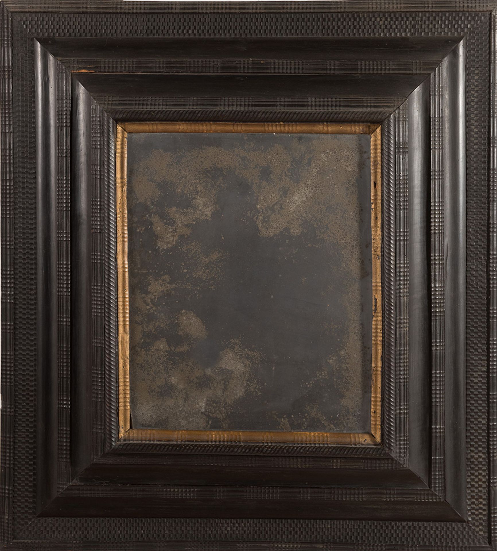 Carved and ebonized Guilloché mirror, late 17th Century