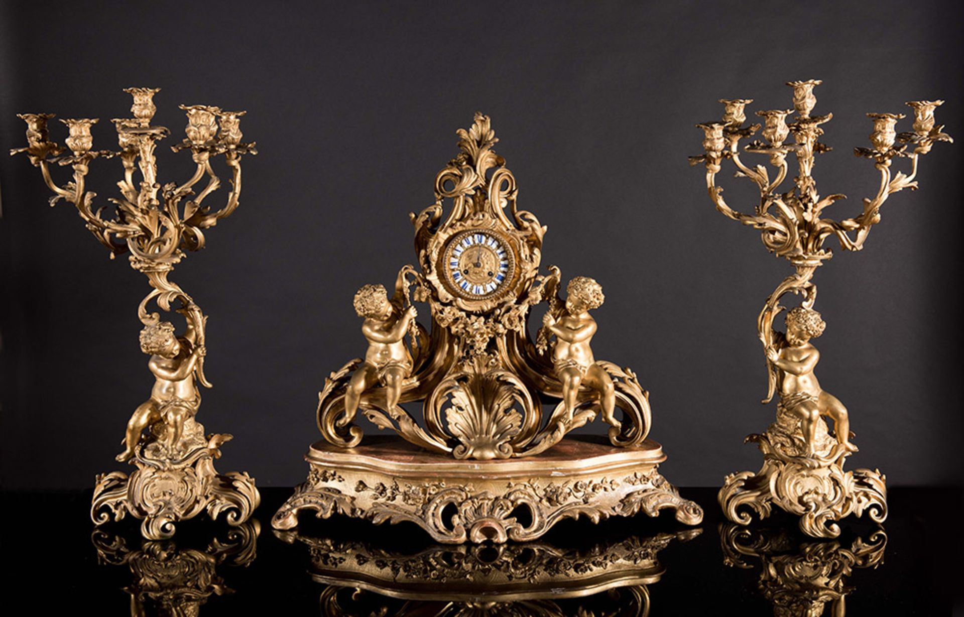 Important gilt metal Napoleon III figural mantel clock and two candelabra.