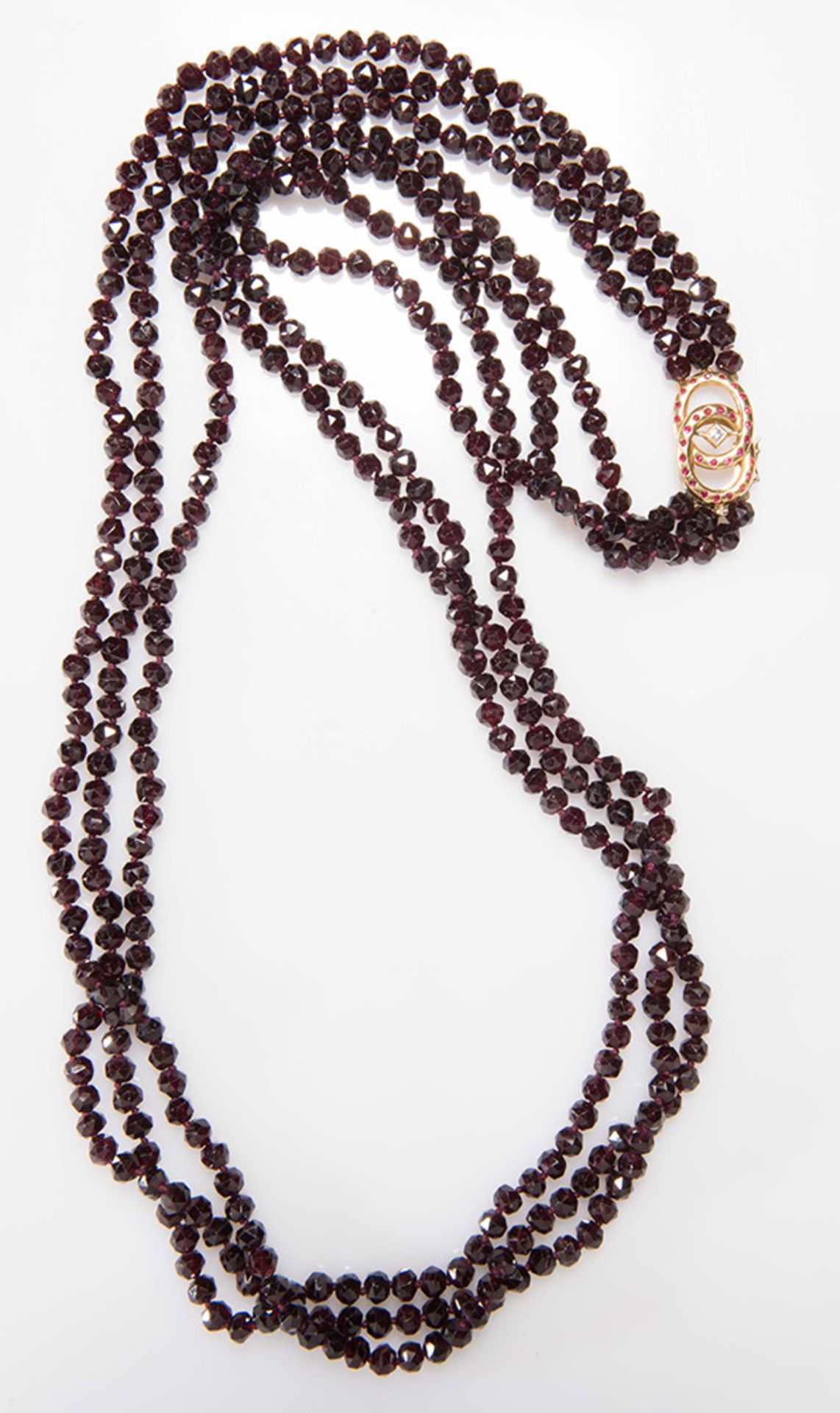 Garnet necklace with diamond, ruby and yellow gold clasp.