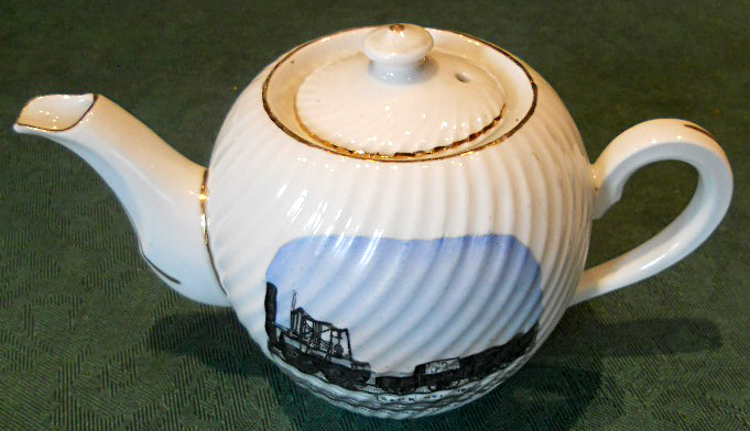 A commemorative one cup tea pot “A PRESENT FROM DARLINGTON” in script to the side of the body and