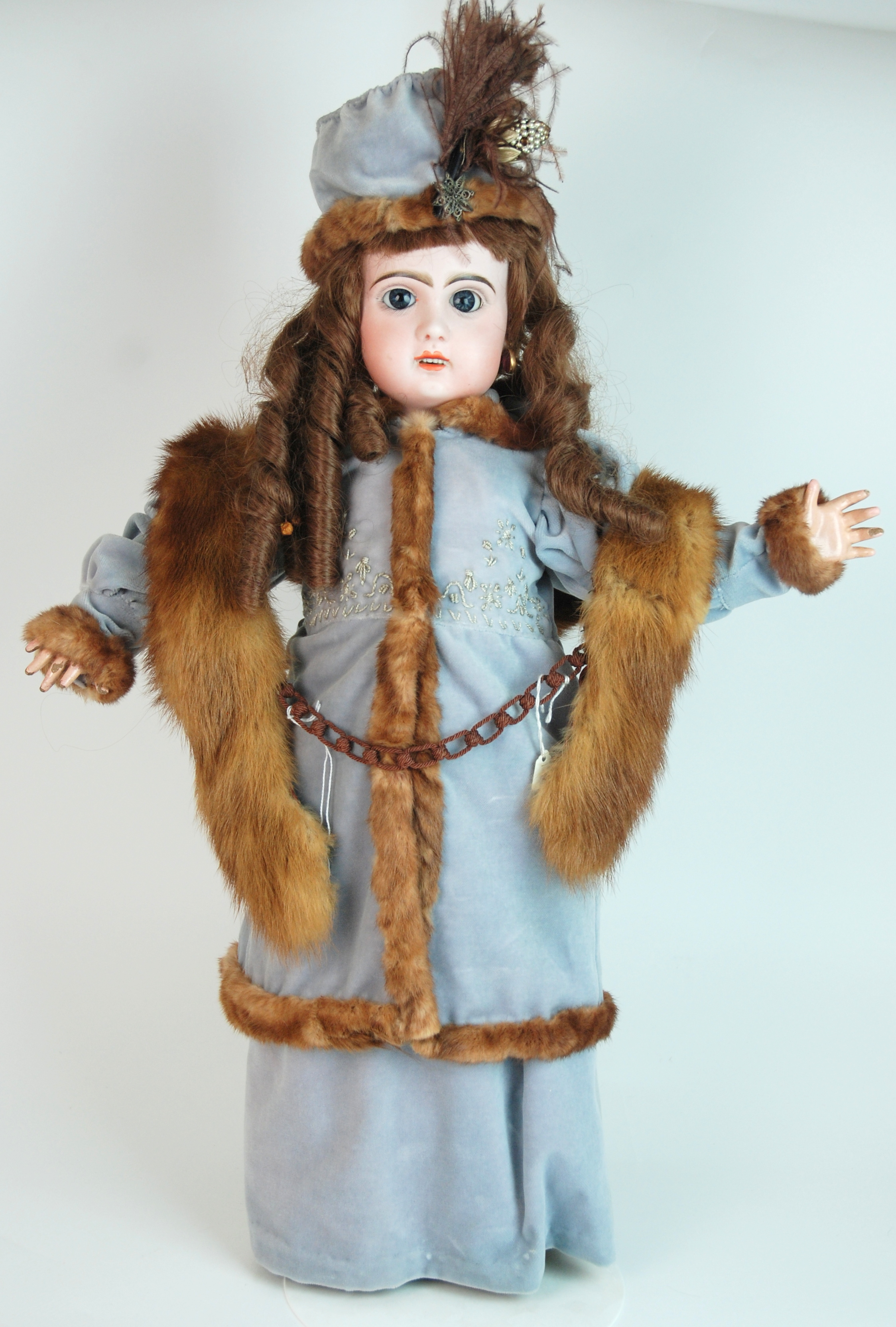 A late Jumeau bisque-headed doll with fixed blue eyes, open mouth, pierced ears and painted