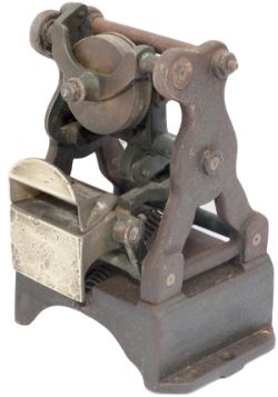 Edmondson ticket dating press, a rare early skeleton type. Cast iron with brass, stands 8in tall.