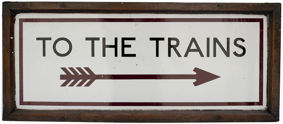 Underground enamel sign in original wooden frame TO THE TRAINS, with Right pointing feathered arrow,