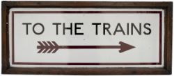 Underground enamel sign in original wooden frame TO THE TRAINS, with Right pointing feathered arrow,