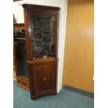 An Edwardian mahogany and inlaid full height corner cabinet with astragal glazed door above a shell