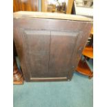 A 19th century oak wall cabinet with pigeon hole fitted interior.