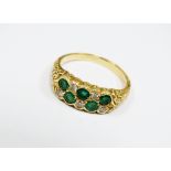 An 18ct gold ten stone emerald and diamond dress ring, ring size N, weight 5.