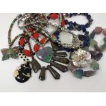 A collection of various hardstone and ornamental necklaces,