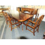 A Regency style mahogany twin pillar dining table with two extra leaves and six (4 + 2) George III