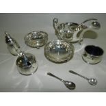 A cased silver sauceboat and ladle together with a cased silver condiment set and a cased pair of
