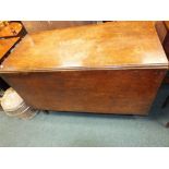 A George III mahogany drop-leaf dining table.