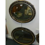 Two oval wall mirrors, probably Irish, the parcel gilt frames with faceted glass bosses.