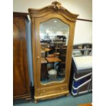 A French stripped pine armoire with single mirror door above a drawer.