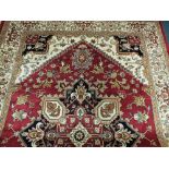 A modern Heriz style carpet approximately 2 metres 30cm x 1 metre 60cm