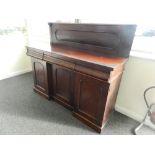 A Victorian mahogany sideboard with three shaped frieze drawers above an inset cupboard door