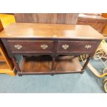 A 20th century oak two drawer dresser base with planked pot board.