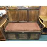 An 18th century style three panel box seat settle with open arms